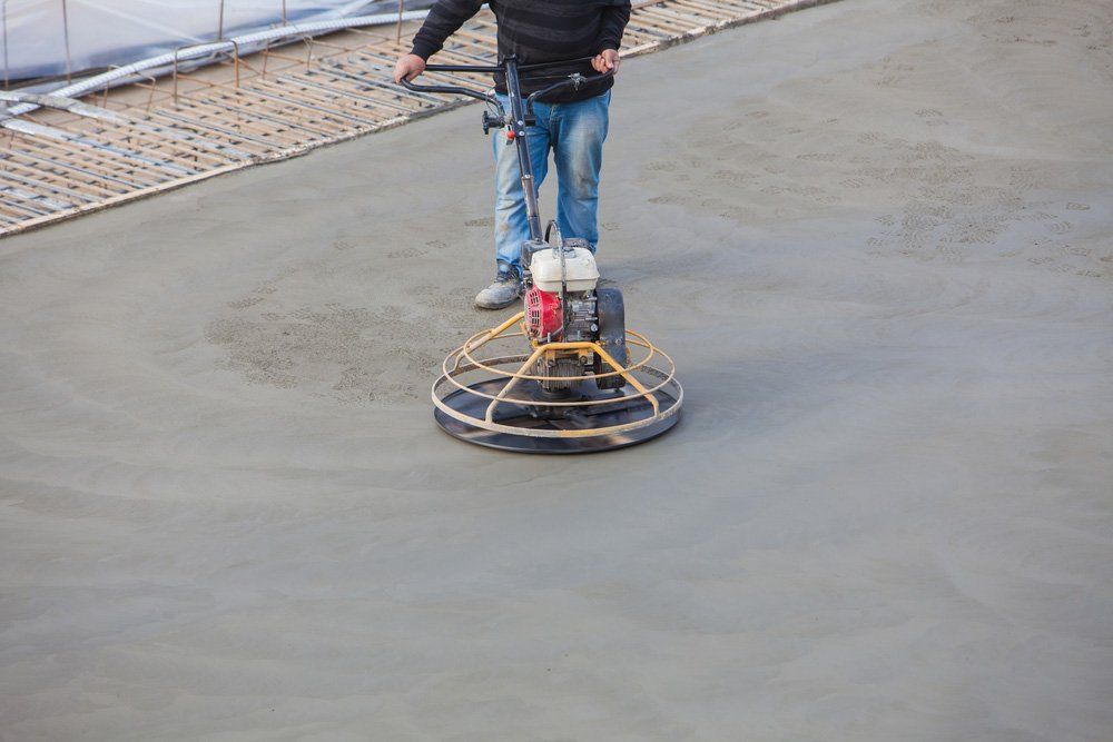 Construction Worker Produces The Grout And Finish Wet Concrete With A Special Tool — Maitland Concreting Specialists In Port Stephens NSW