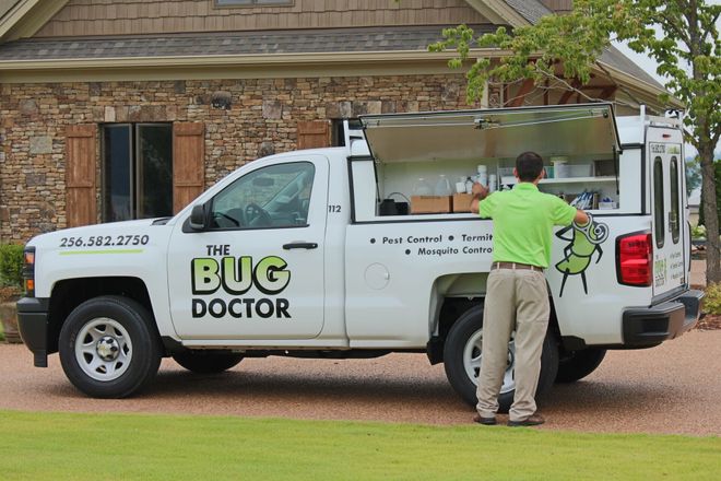 Worker looking at the white truck — Guntersville, AL — Bug Doctor