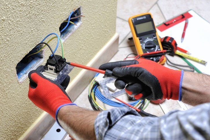 Electrician Working on Electrical Outlet