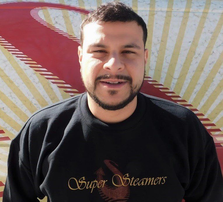 Man in black sweatshirt with 