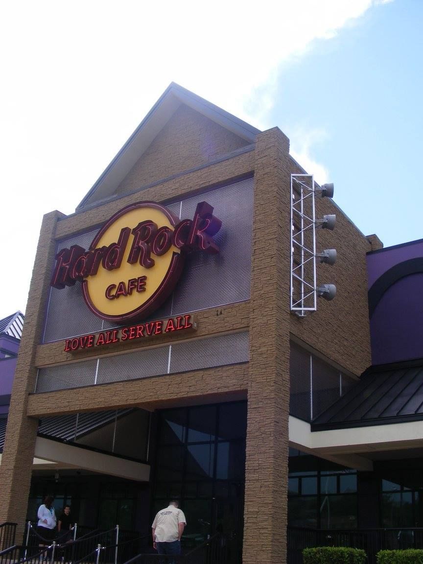 A hard rock cafe with a purple awning