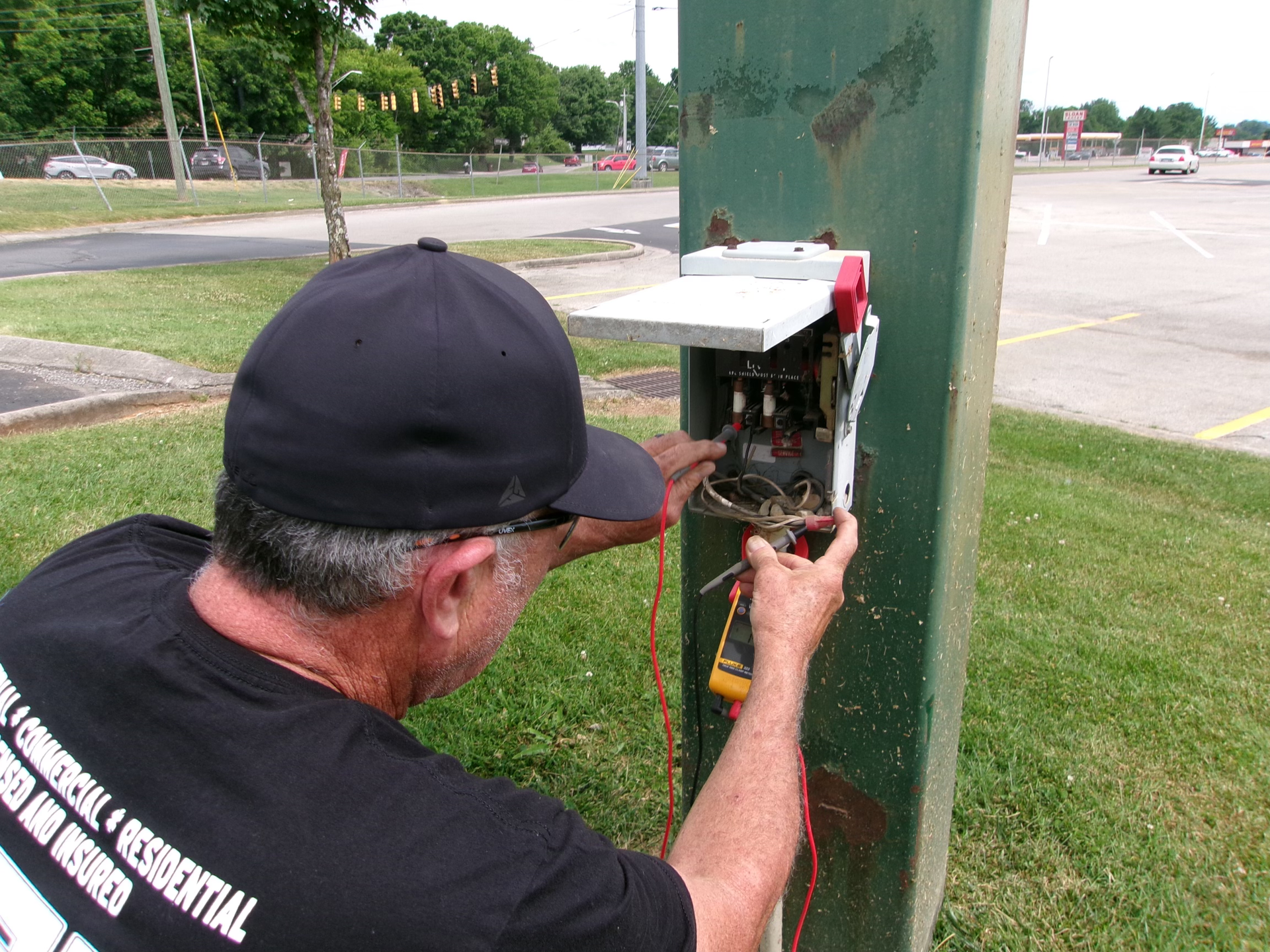 A man wearing a black shirt with the word residential on it