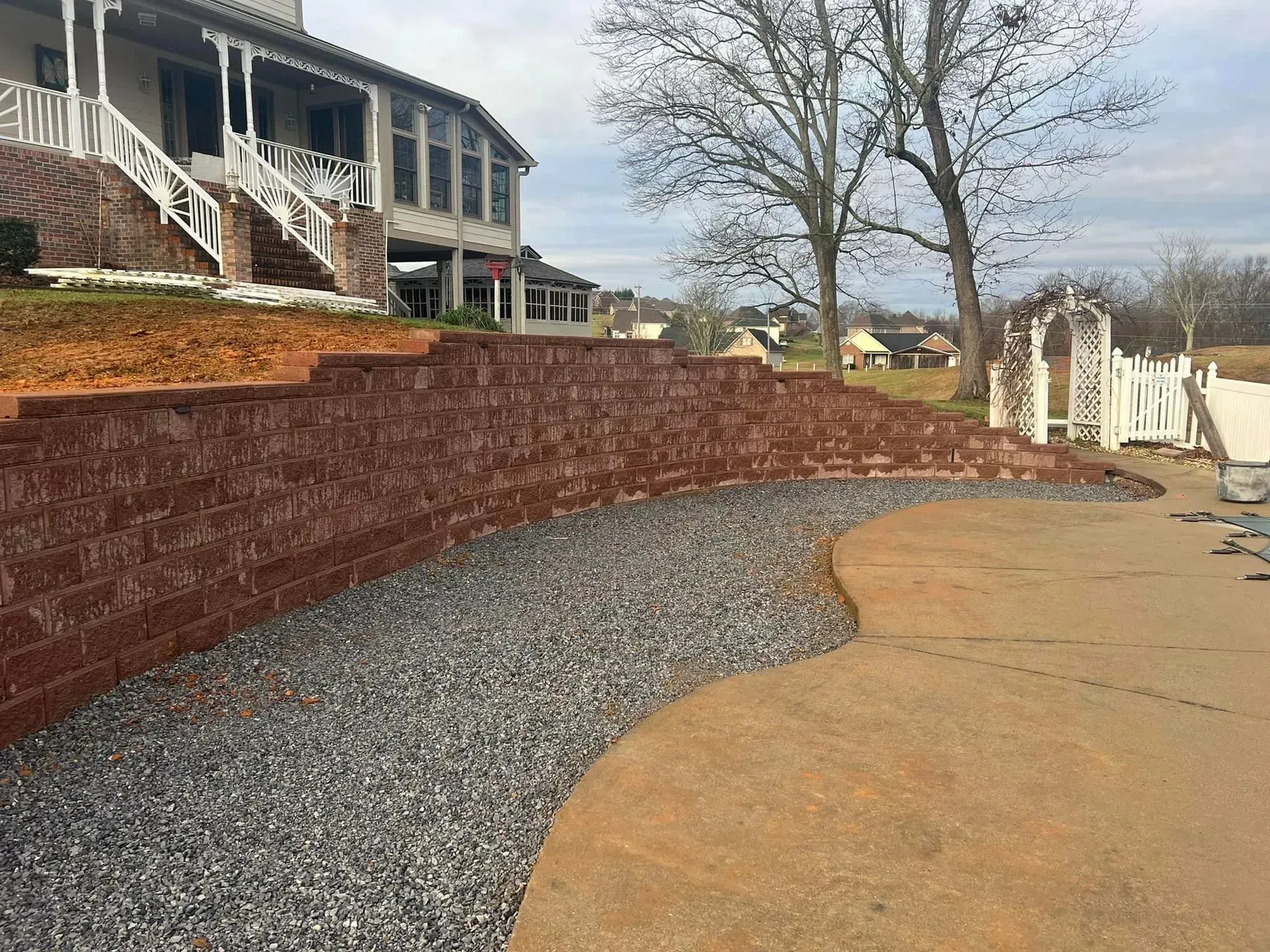A brick wall is being built in front of a house.