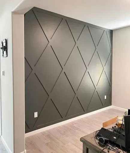 Gray accent wall with diamond pattern, light-colored floor, and white trim.