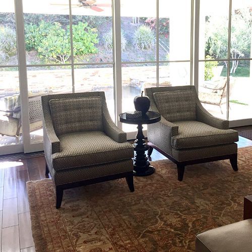 A living room with two chairs and a table.