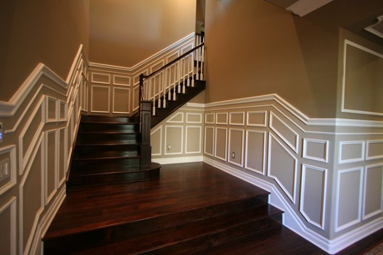 A staircase in a house with a wooden railing.