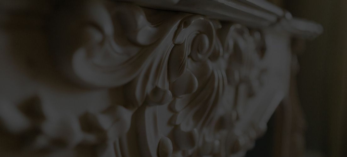 A close up of a carving on a wall in a dark room.