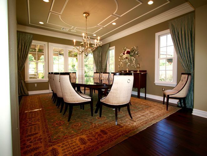 A dining room with a long table and chairs.