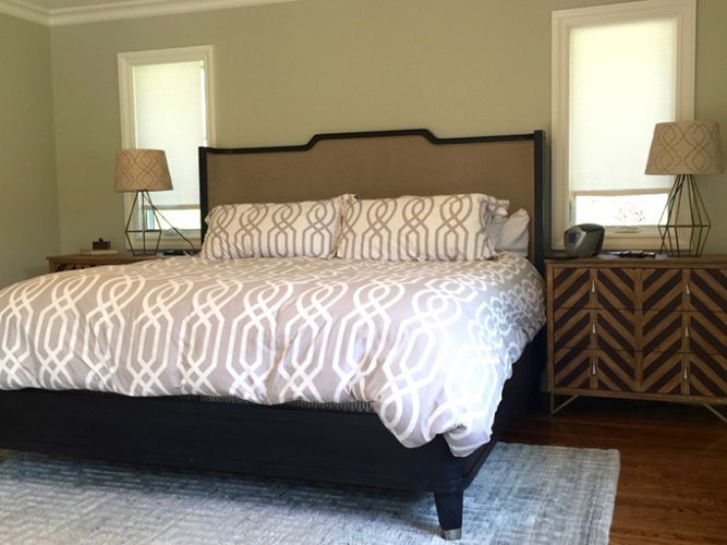 A bedroom with a king-size bed and two nightstands.