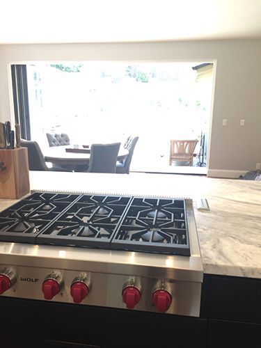 A stove top oven is sitting on top of a counter in a kitchen.