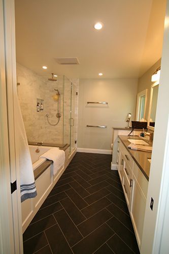 A bathroom with a bathtub, sink, and shower.