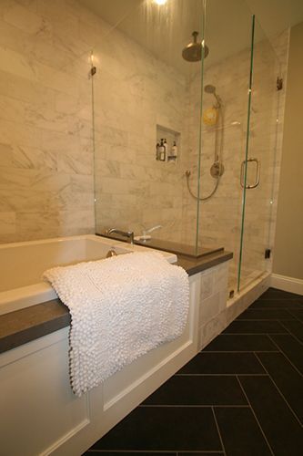 A bathroom with a bathtub and a walk in shower.