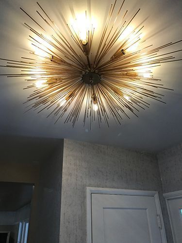 A chandelier is hanging from the ceiling in a room.