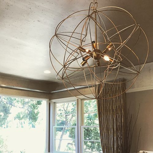A chandelier is hanging from the ceiling in a living room