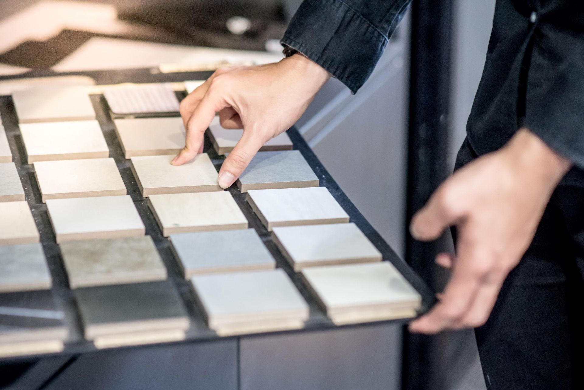 A person is looking at a display of tiles in a store.
