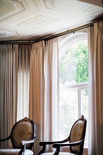 Two chairs are sitting in front of a window in a living room.