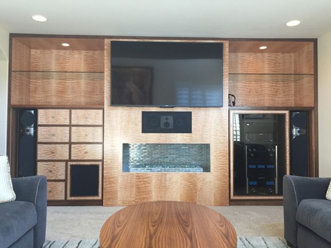 A living room with a fireplace and a flat screen tv.