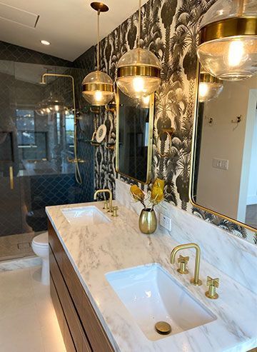 A bathroom with two sinks, a toilet, and a large mirror.