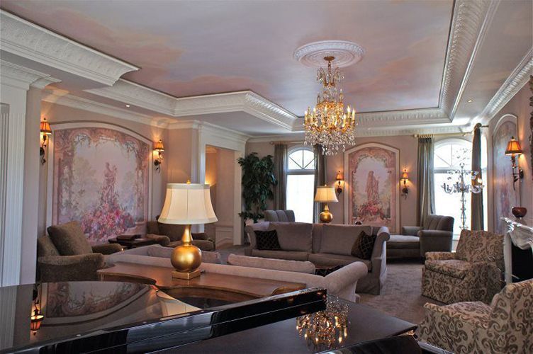 A living room with a piano and a chandelier.