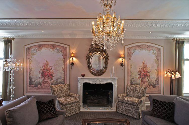 A living room with a fireplace and a chandelier.