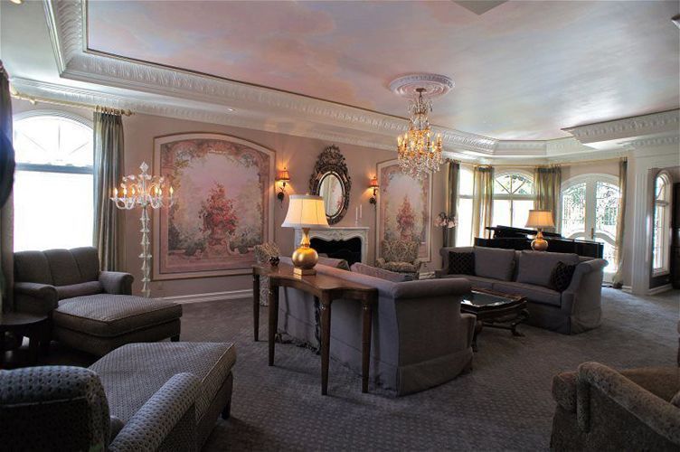 A living room with a lot of furniture and a chandelier.