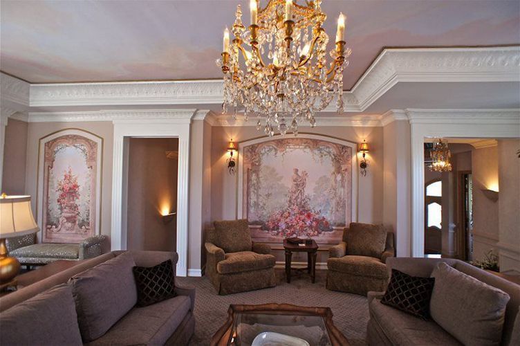 A living room filled with furniture and a chandelier.
