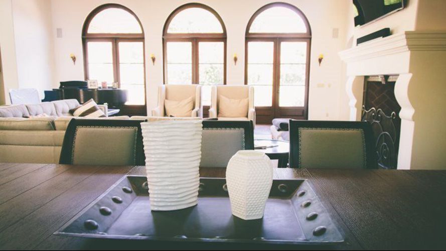 A tray with vases on it is on a table in a living room.