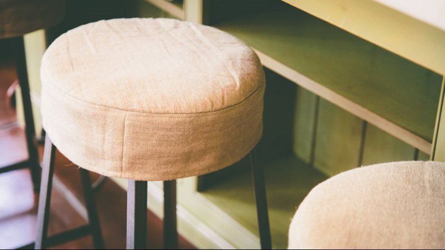 Two stools are sitting next to each other on a table.