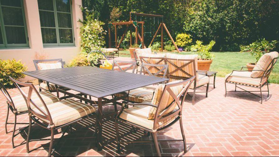 A patio with a table and chairs on it.