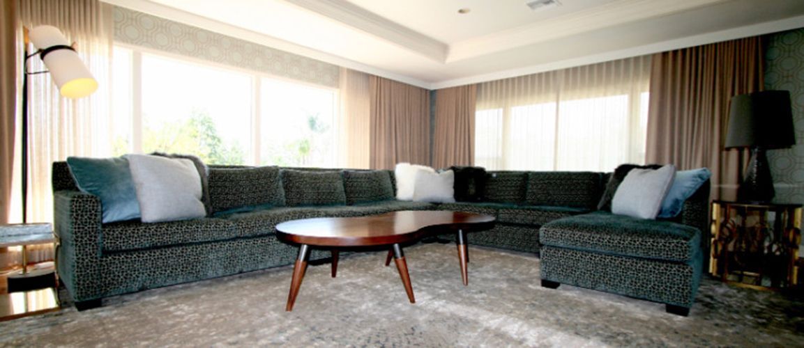 A living room with a large sectional couch and a coffee table.