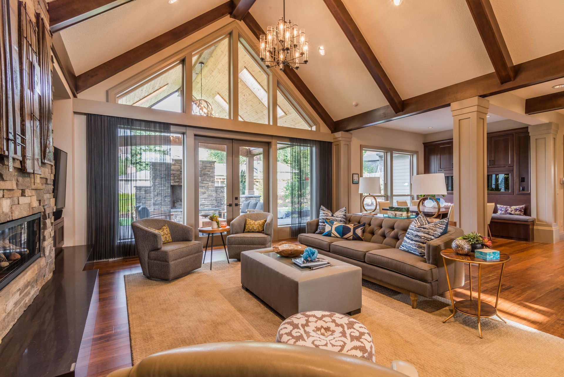 A living room with a lot of furniture and a vaulted ceiling.
