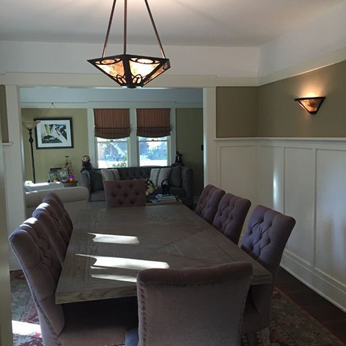 A dining room with a table and chairs and a chandelier.