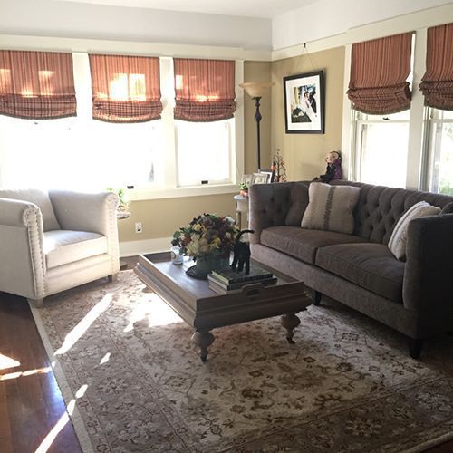 A living room with a couch a chair and a coffee table.