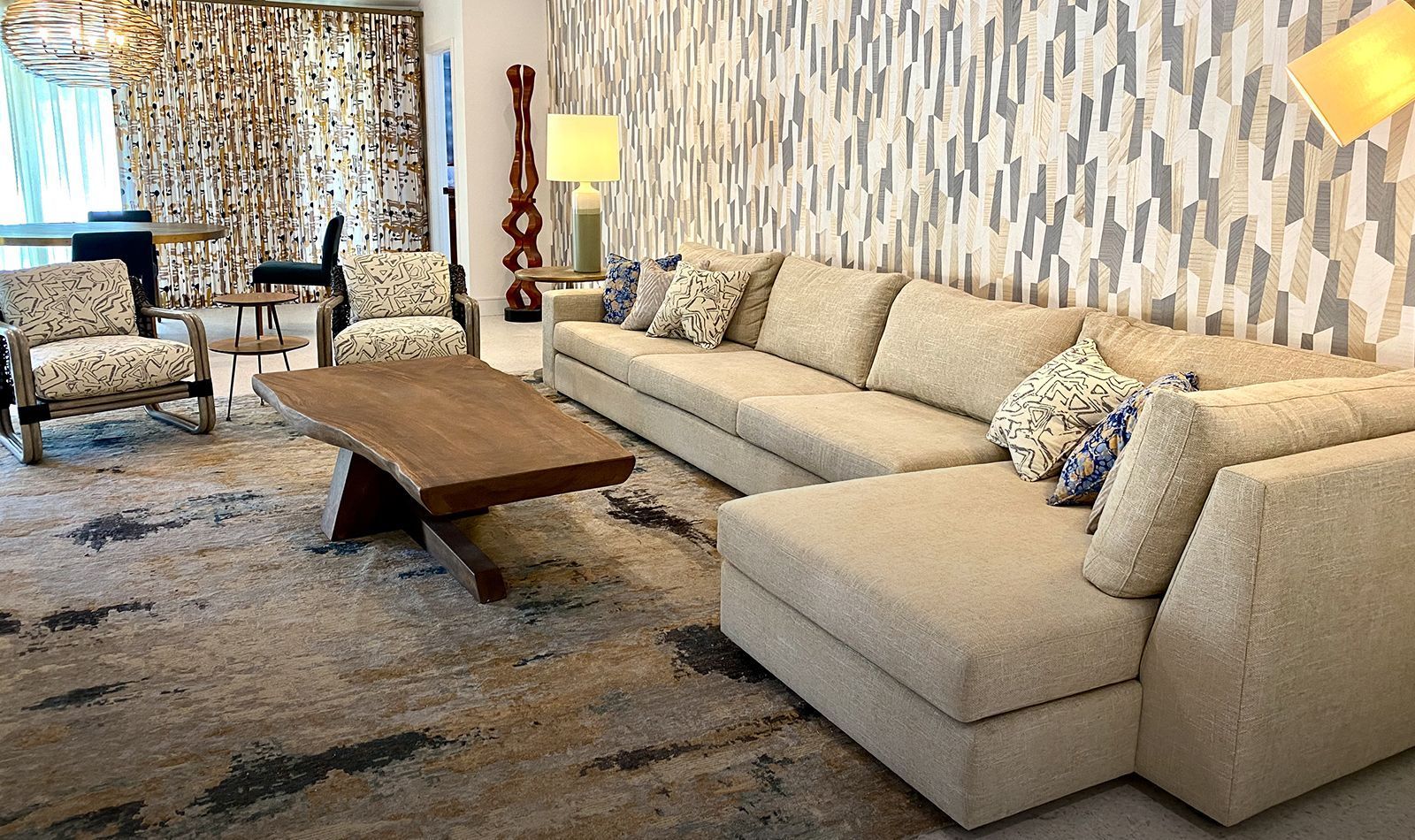 A living room with a couch, chairs, and a coffee table.