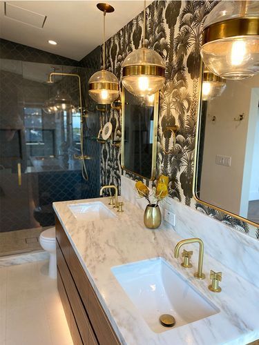 A bathroom with two sinks, a toilet and a shower.