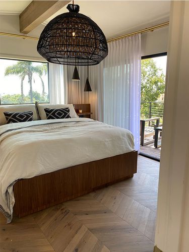 A bedroom with a large bed and a large window.