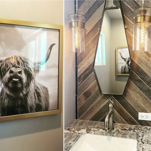 A bathroom with a picture of a cow on the wall and a sink.