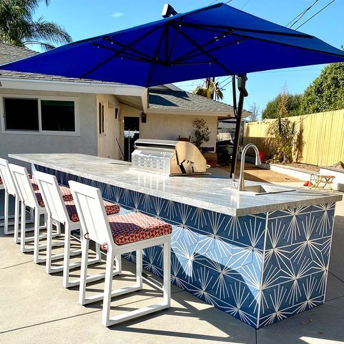 A large blue umbrella is sitting on top of a patio table.