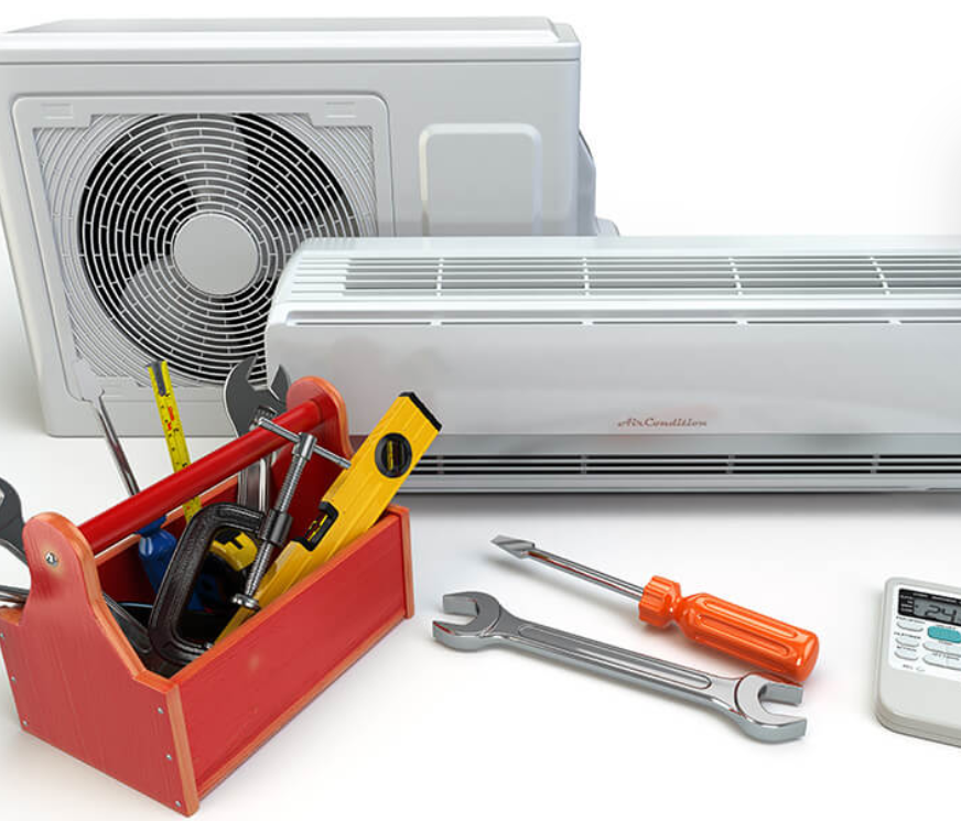 A man wearing a hard hat is working on an air conditioner.