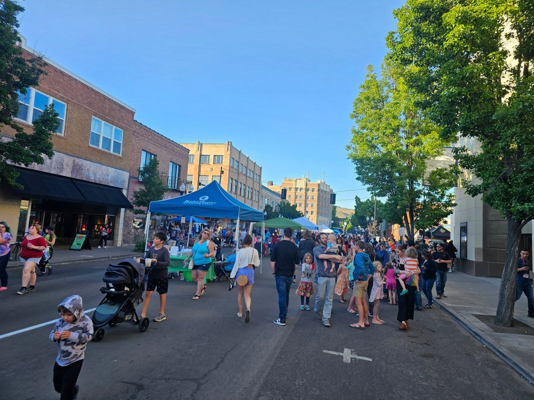 A group of people are walking down a city street.