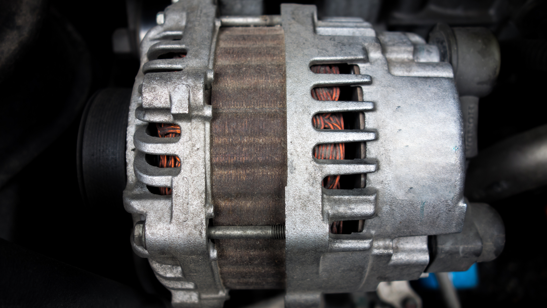 Car tire changed on side of road, with jack, wrench, and spare tire.