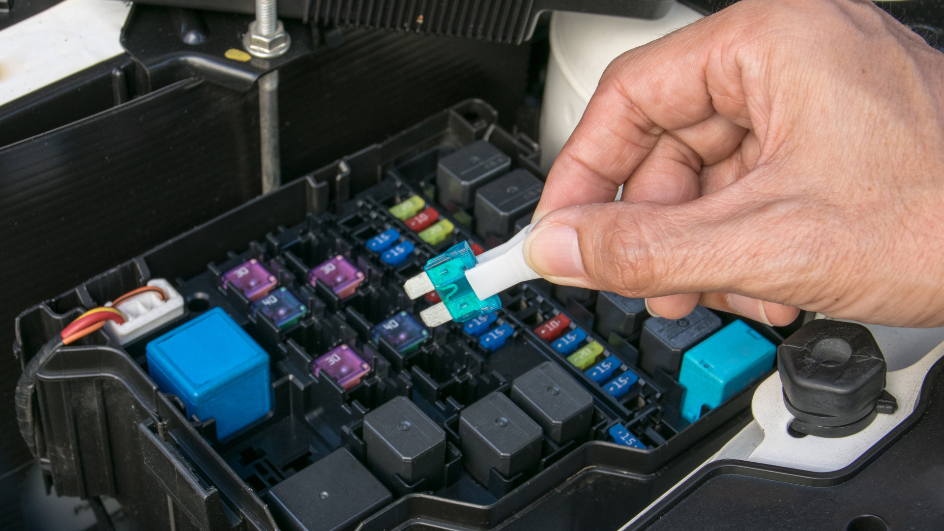 Close-up of a car engine, showing belts, pulleys, and other components in a metallic setting.