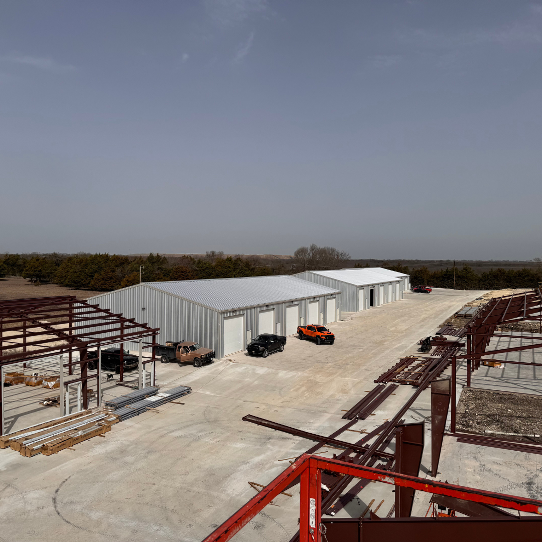 An aerial view of BT Garages with a building under construction with trucks parked in front of it.