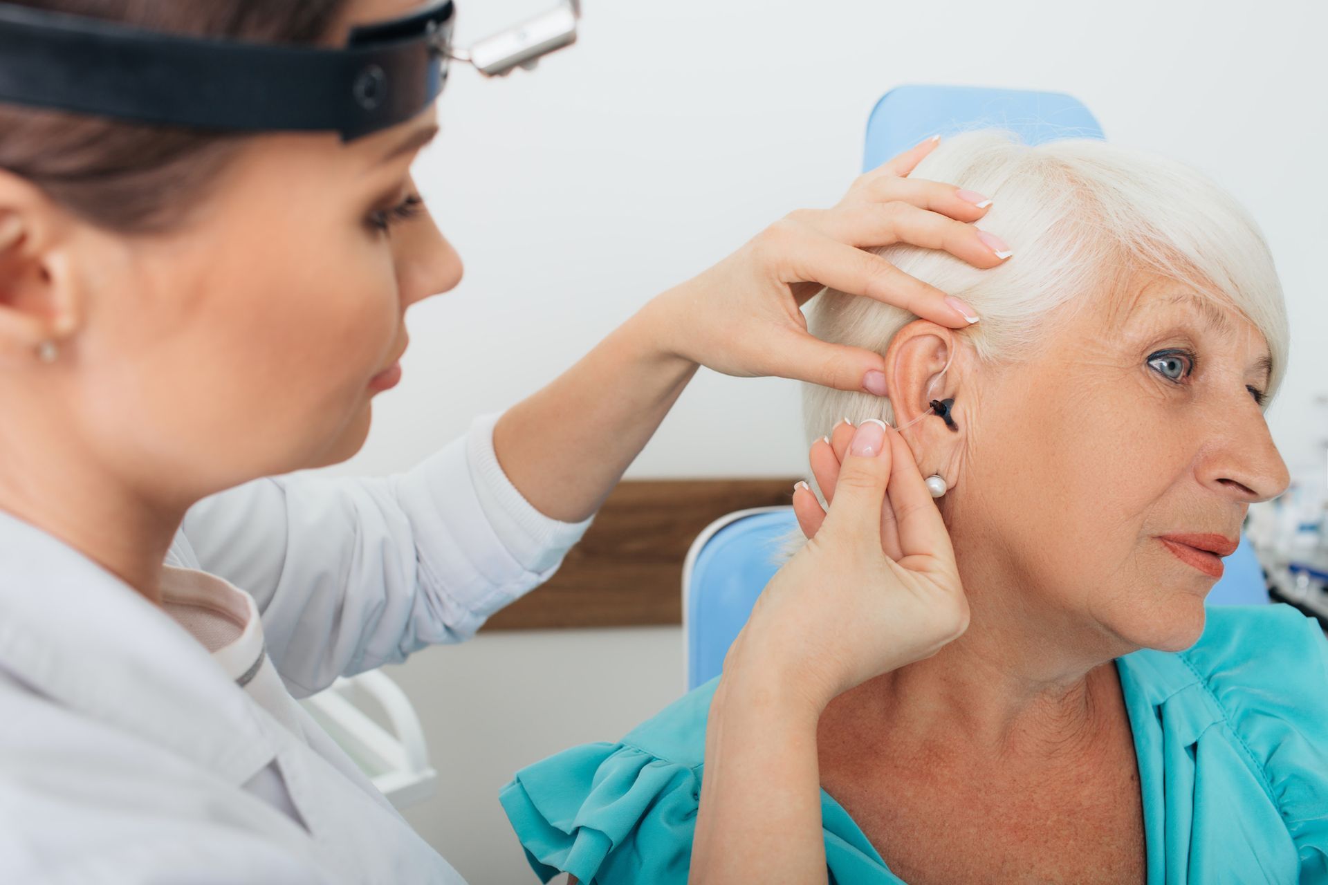 A doctor checking an old person's ear | Hearing Exams in Lake Mary, FL A doctor checking an old person's ear | Hearing Exams in Lake Mary, FL