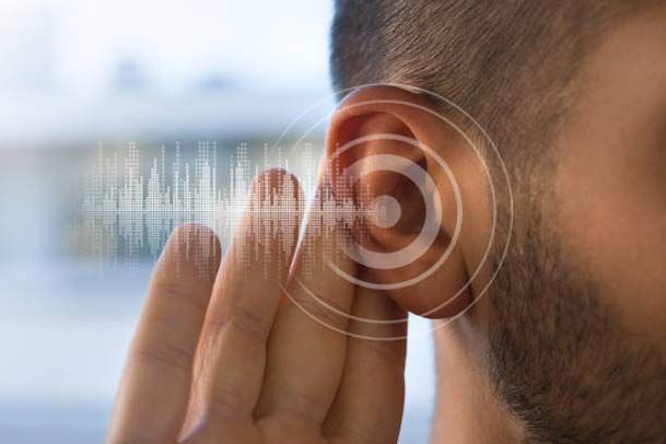 Close-up of ear with hand cupped and sound waves indicating listening.