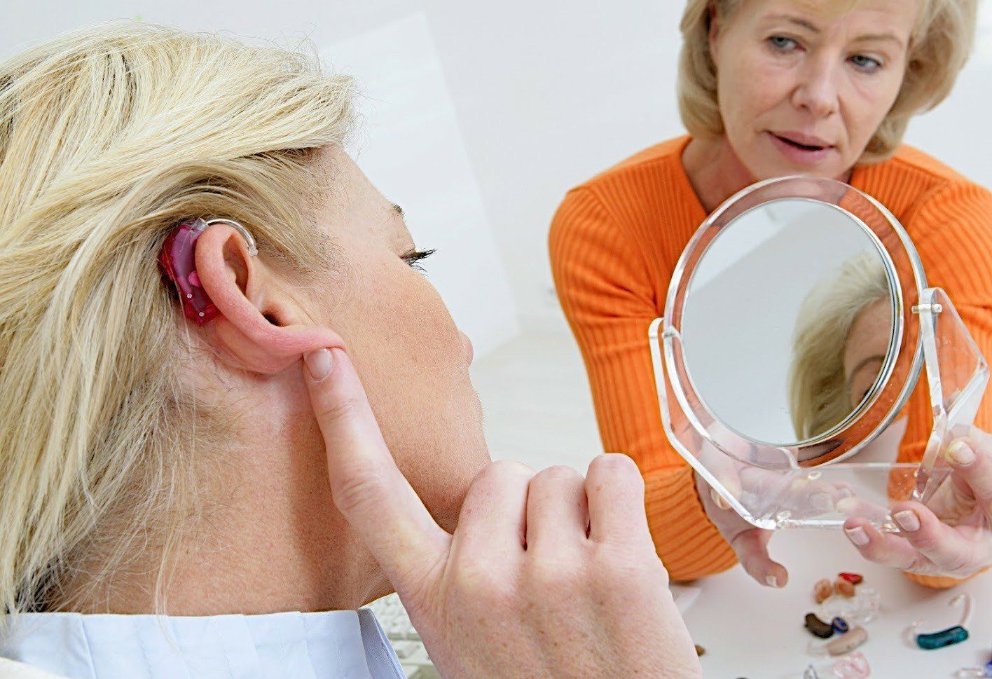 Woman Checking Her Hearing Aid — Sanford FL — Accurate Heating Technology Inc