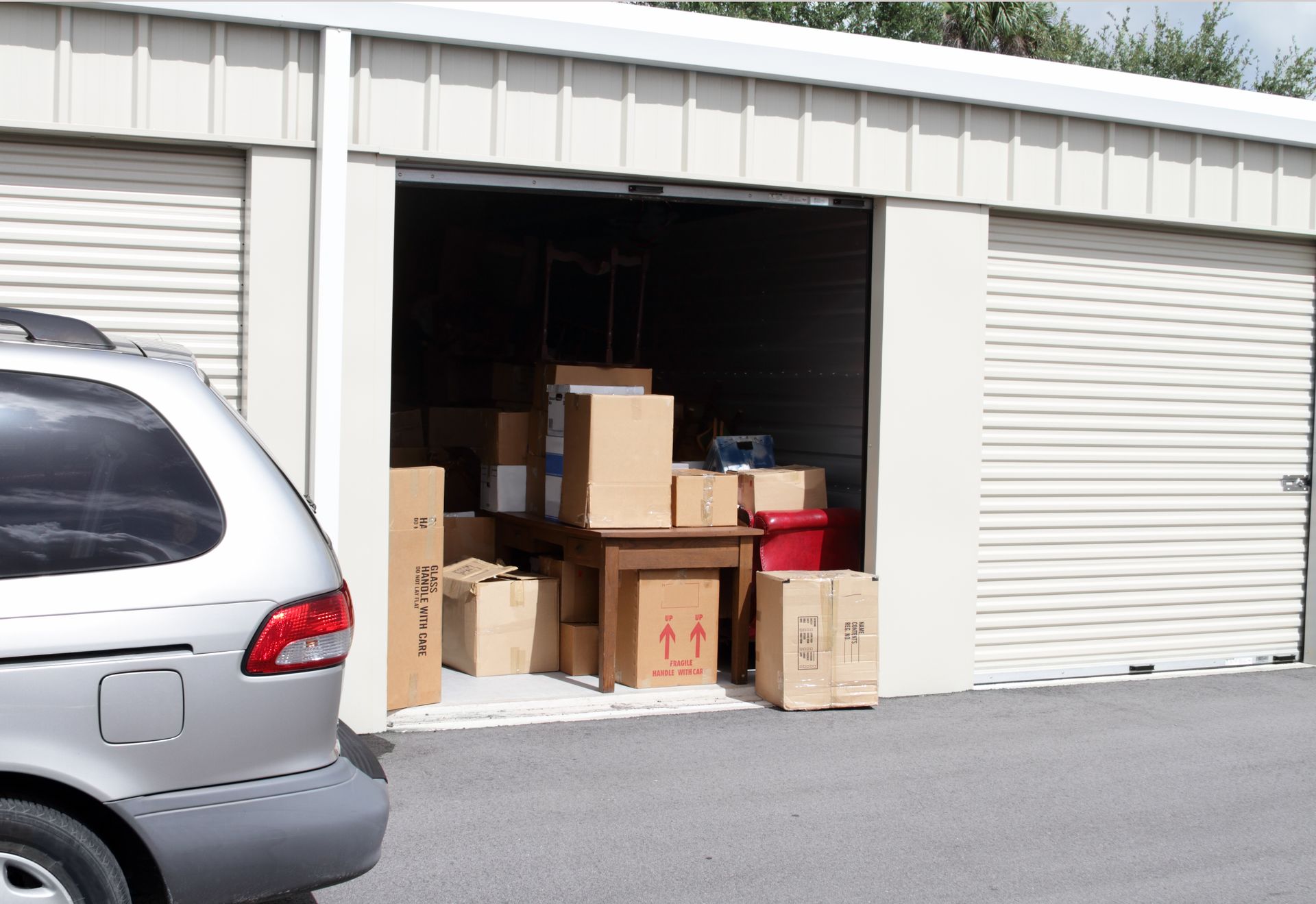 Senior male unlocking a storage unit at Central Virginia Storage a company that provides storage units in Henrico, VA