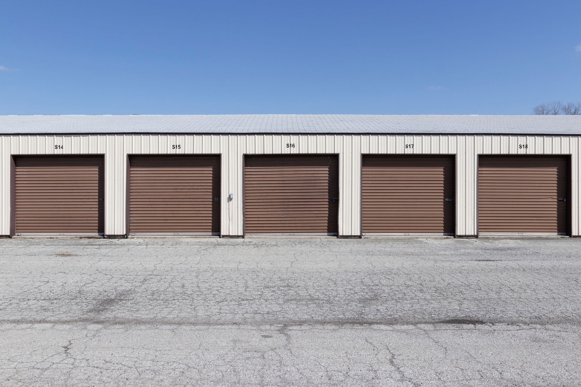 Self-storage and mini storage garage units in an outdoor setting. Self-storage and mini storage garage units in an outdoor setting.