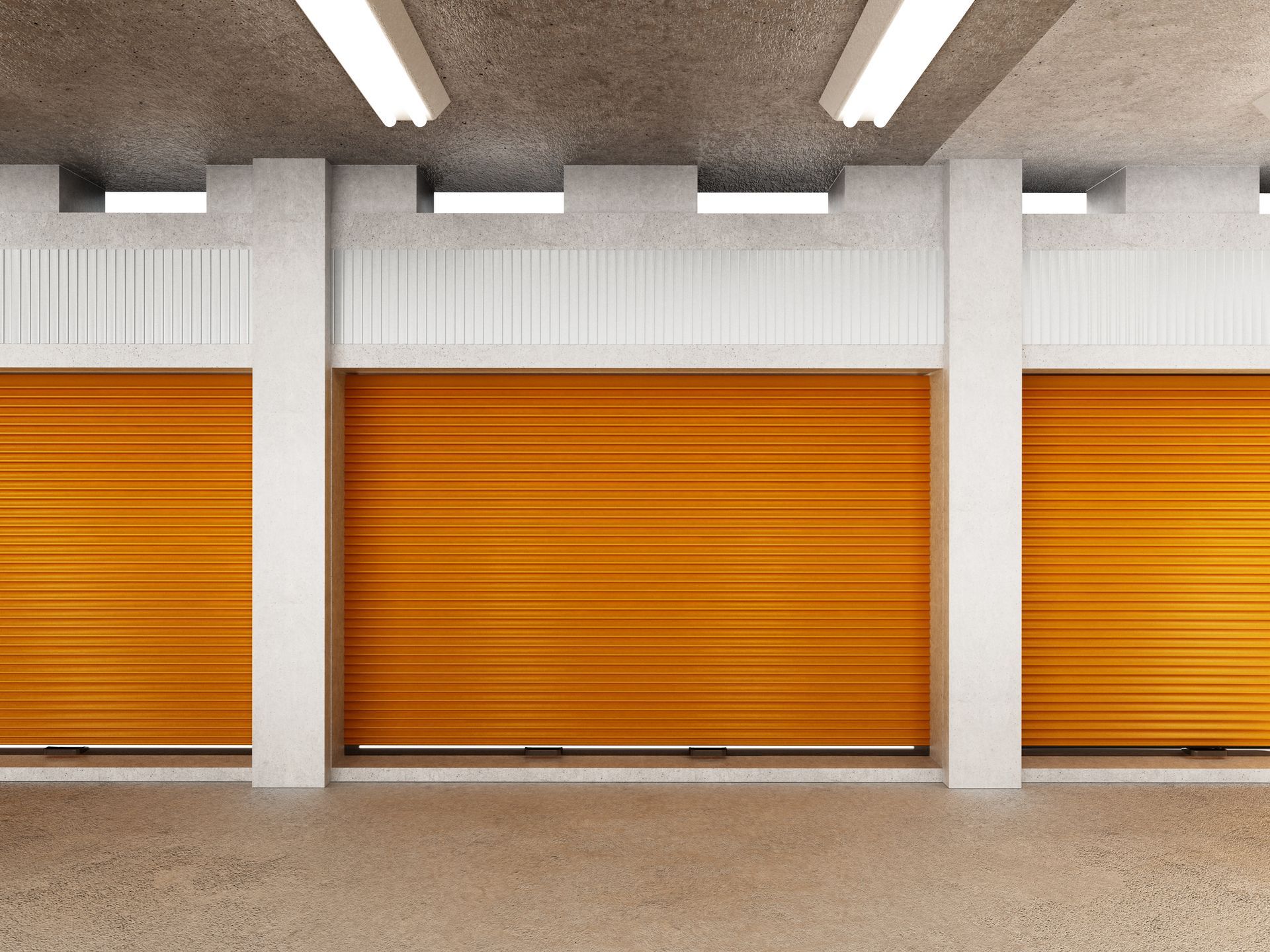 Storage units with orange roller doors in a warehouse, ideal for seasonal & household storage needs.