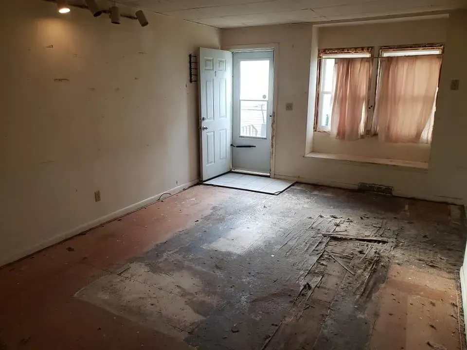 An empty room with a door and a window